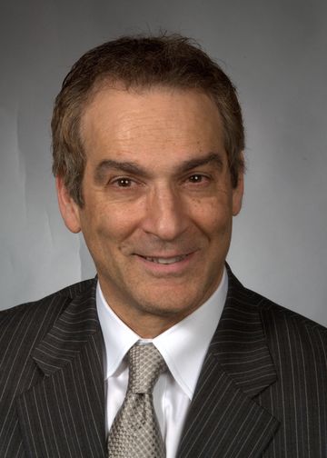 Gene Coppa, MD, wearing a grey pinstriped suit